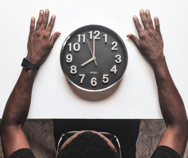 round silver colored wall clock