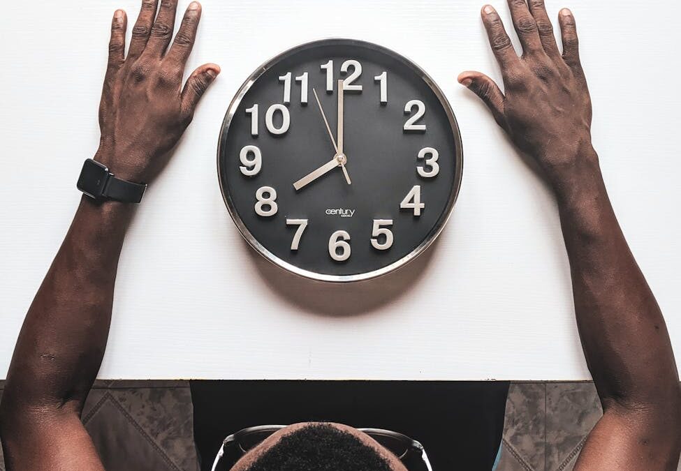 round silver colored wall clock