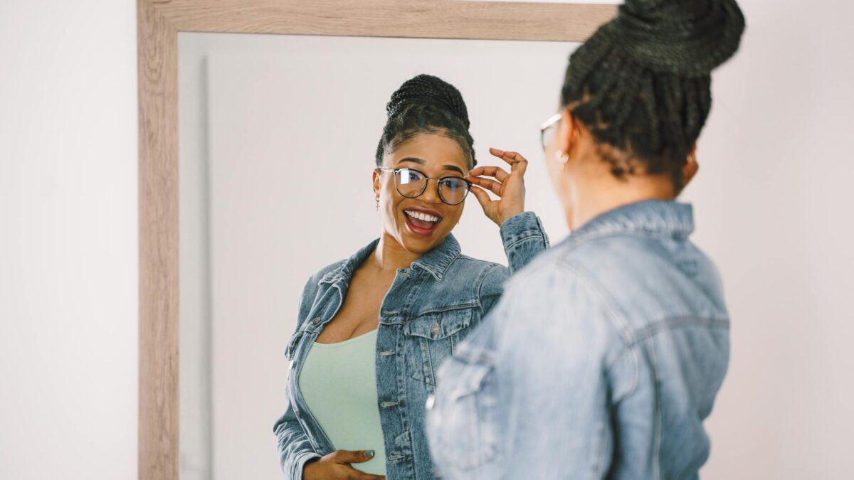 reflection of smiling woman in mirror