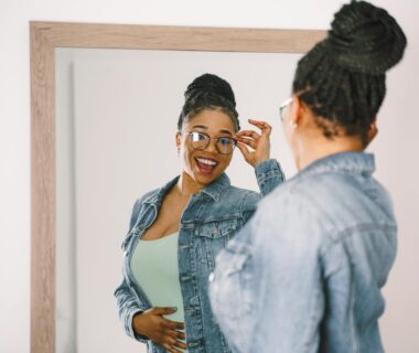 reflection of smiling woman in mirror