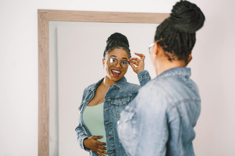 reflection of smiling woman in mirror