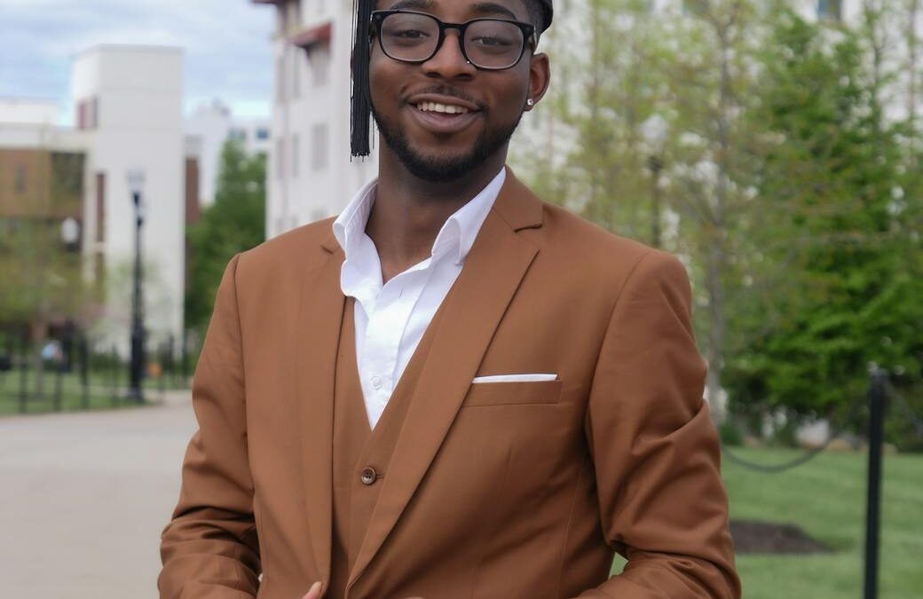 smiling black man in glasses and mortarboard