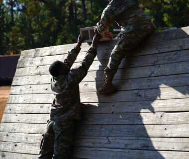 soldiers climbing wooden wall