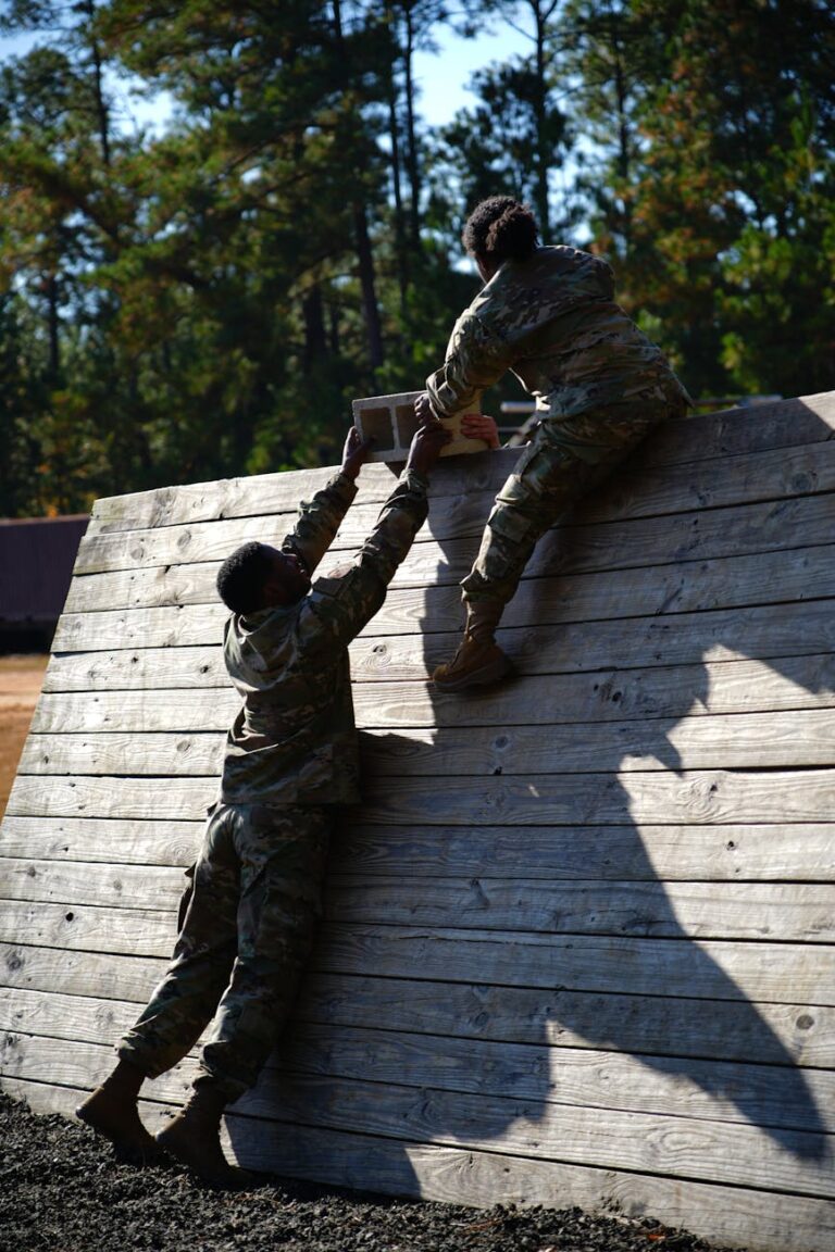 soldiers climbing wooden wall