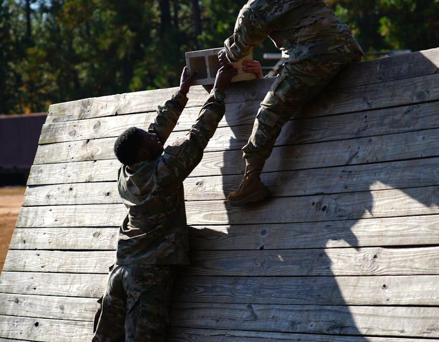 soldiers climbing wooden wall