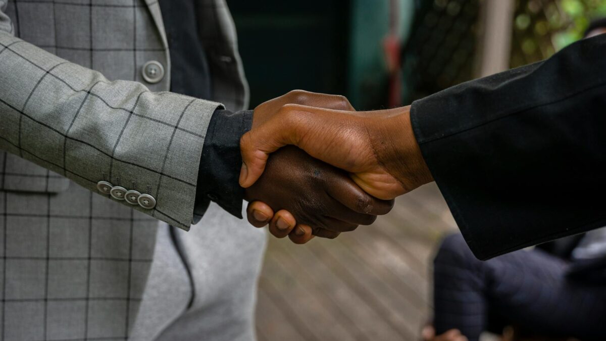 men in suit jackets shaking hands