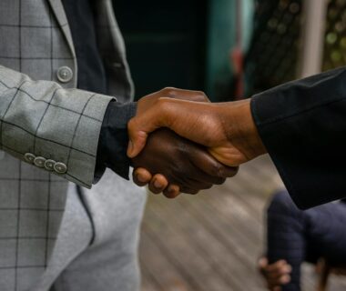 men in suit jackets shaking hands