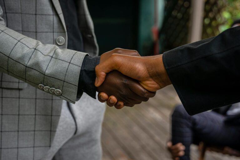 men in suit jackets shaking hands